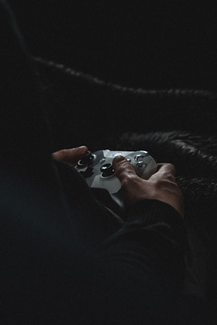 person holding white game controller