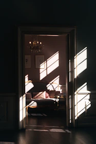 A sunlit suite with plush bedding and elegant furnishings.