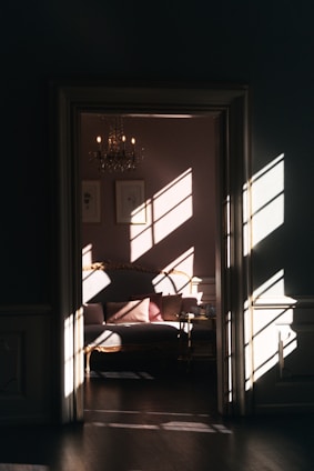 Elegant living room of a luxury suite bathed in natural light, with plush seating and tasteful decor.