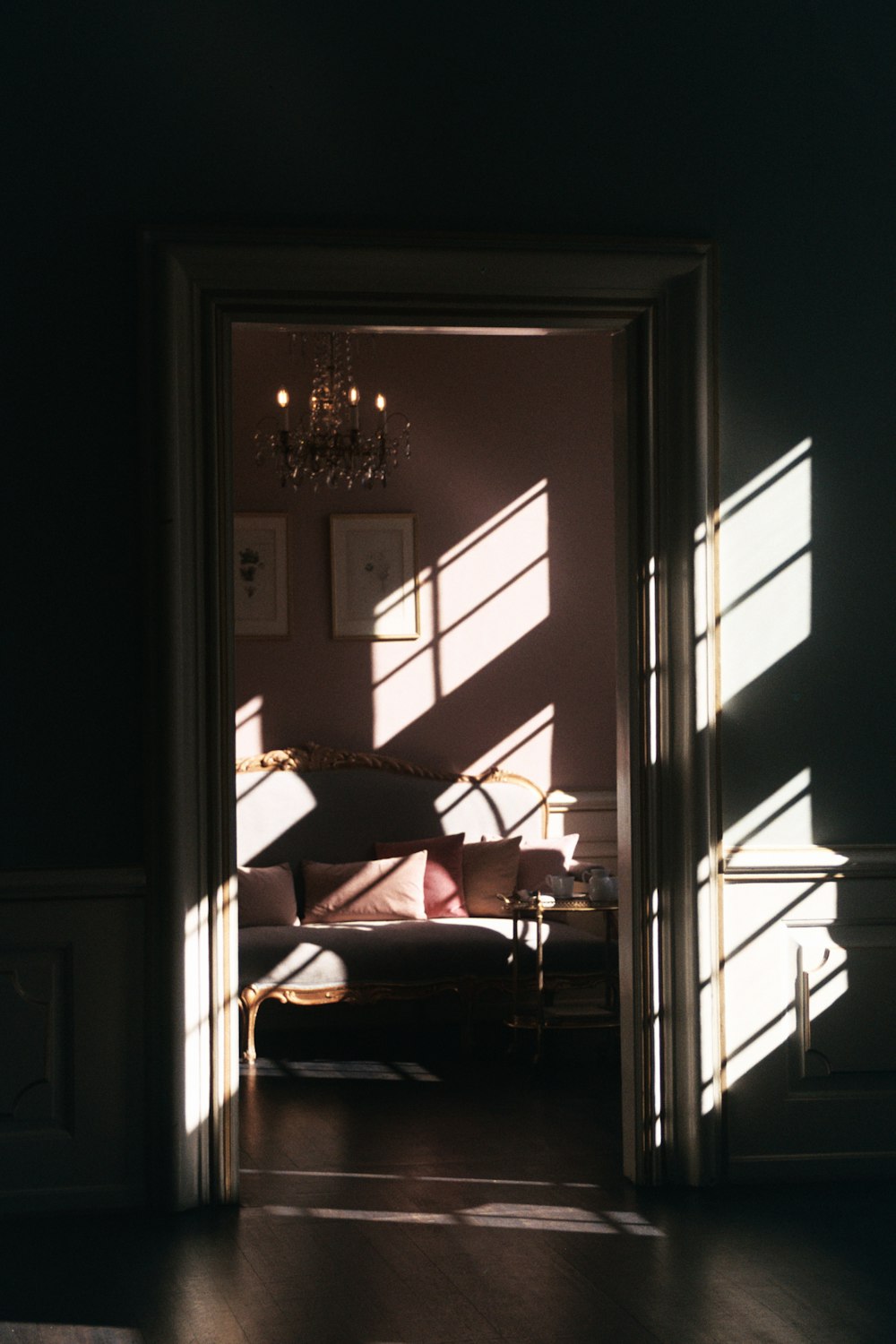 gray padded sofa inside pink room