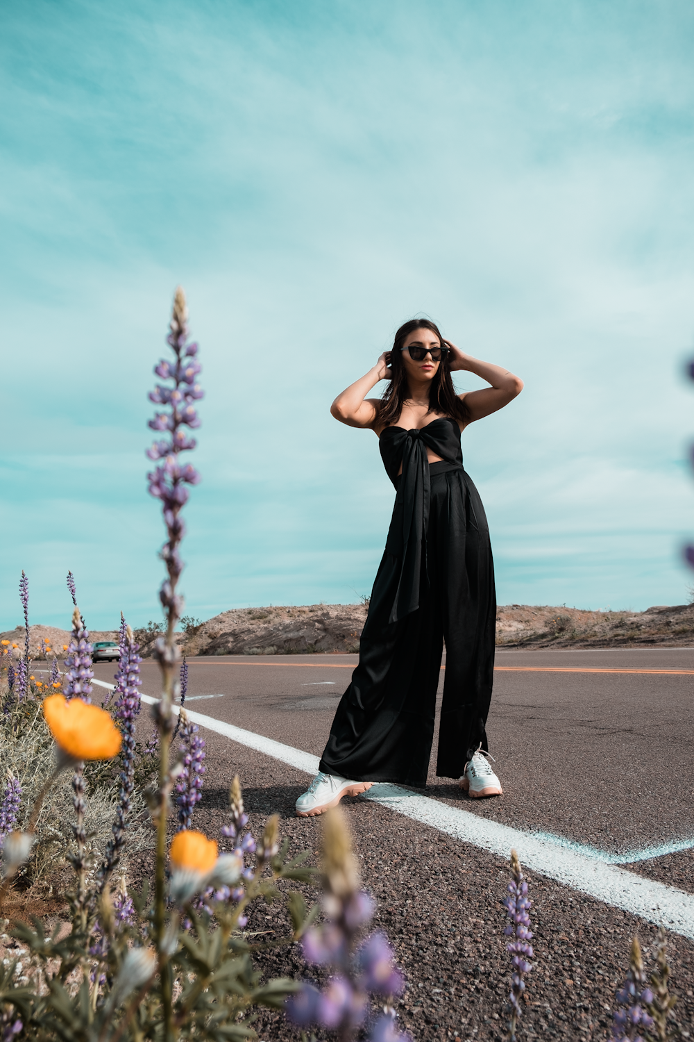 a woman standing in the middle of a road