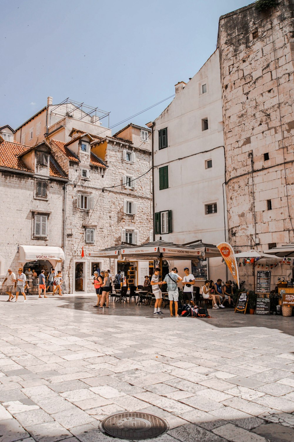 people standing near concrete building at daytime