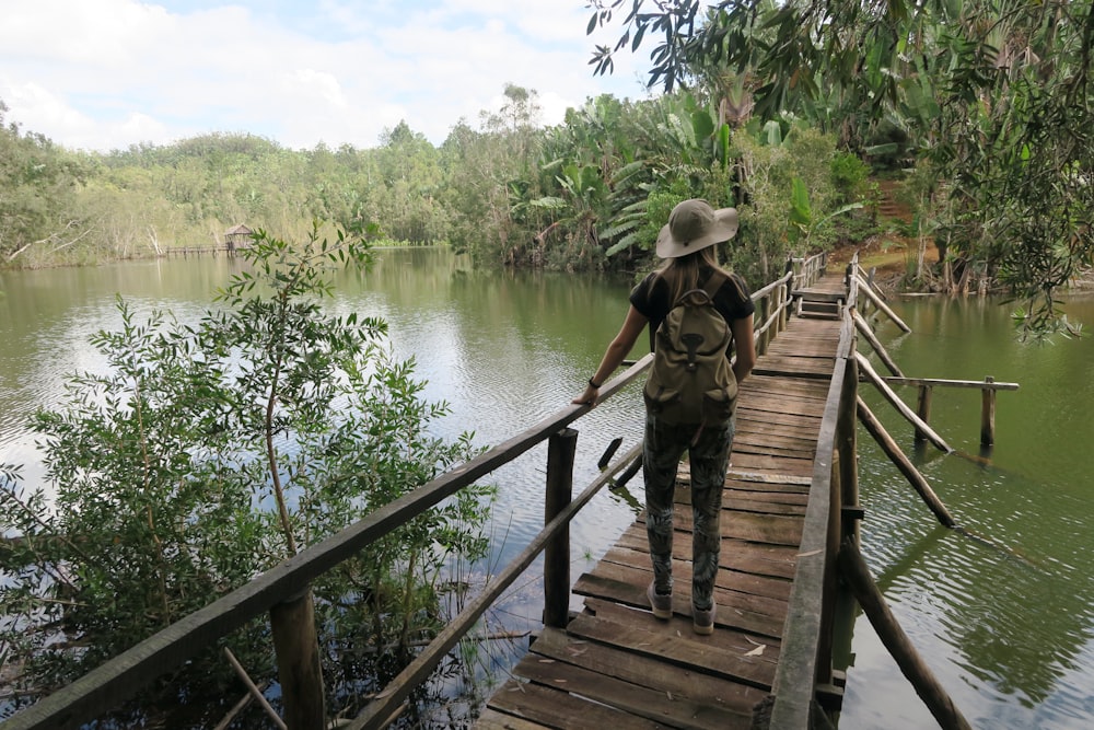 woman walking on wooden bridge