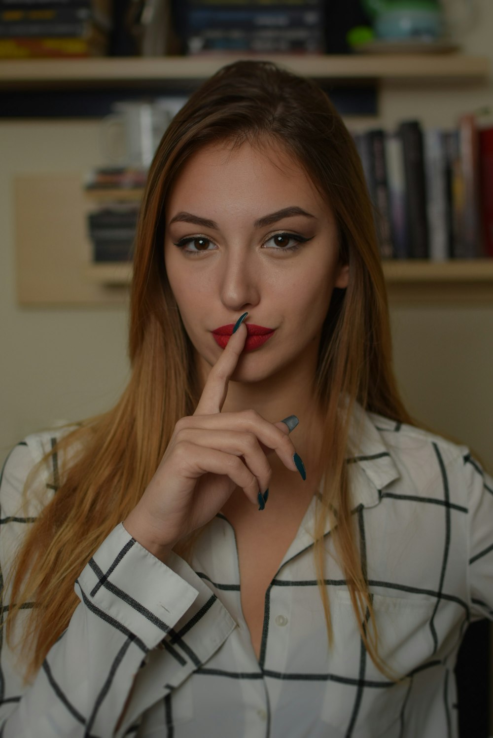 woman putting her index finger closer to her lips