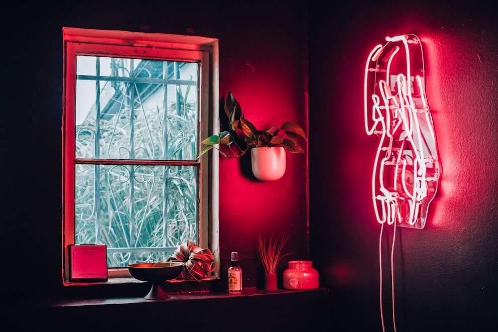 pink neon signage on wall turned-on