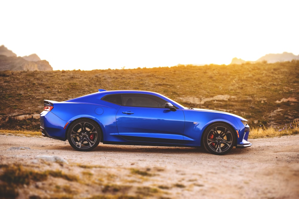 blue coupe on road during daytime