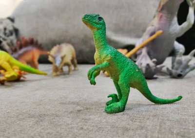 Close-up of vibrant dinosaur drawings from the Nashville Zoo coloring book spread out on a table.