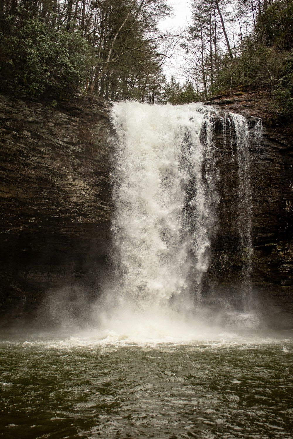 waterfalls cascading down rock slope