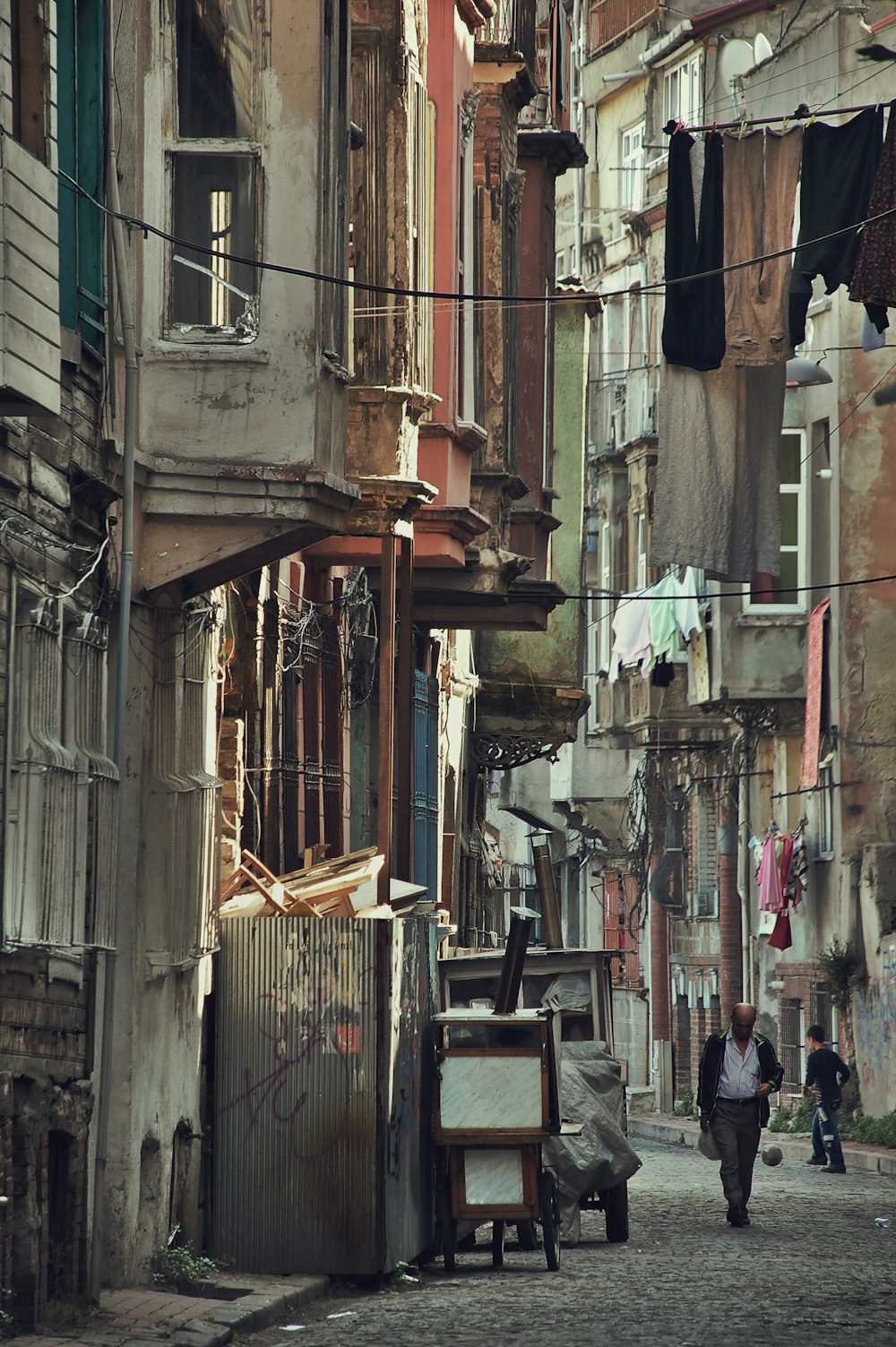 man walking in between building during daytime