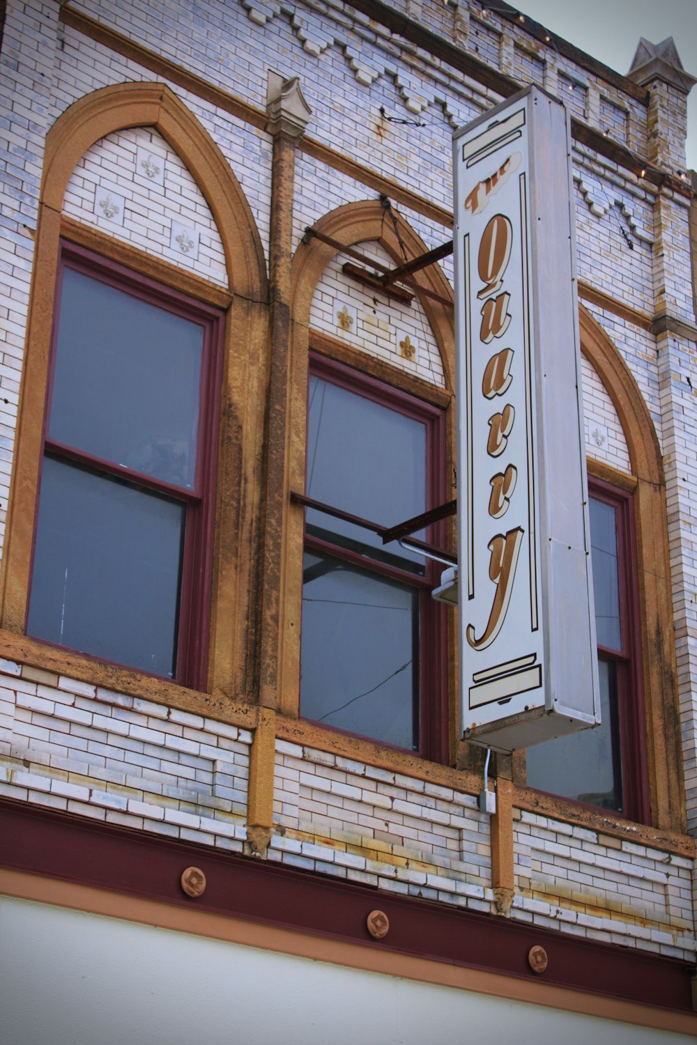 a sign hanging from the side of a building