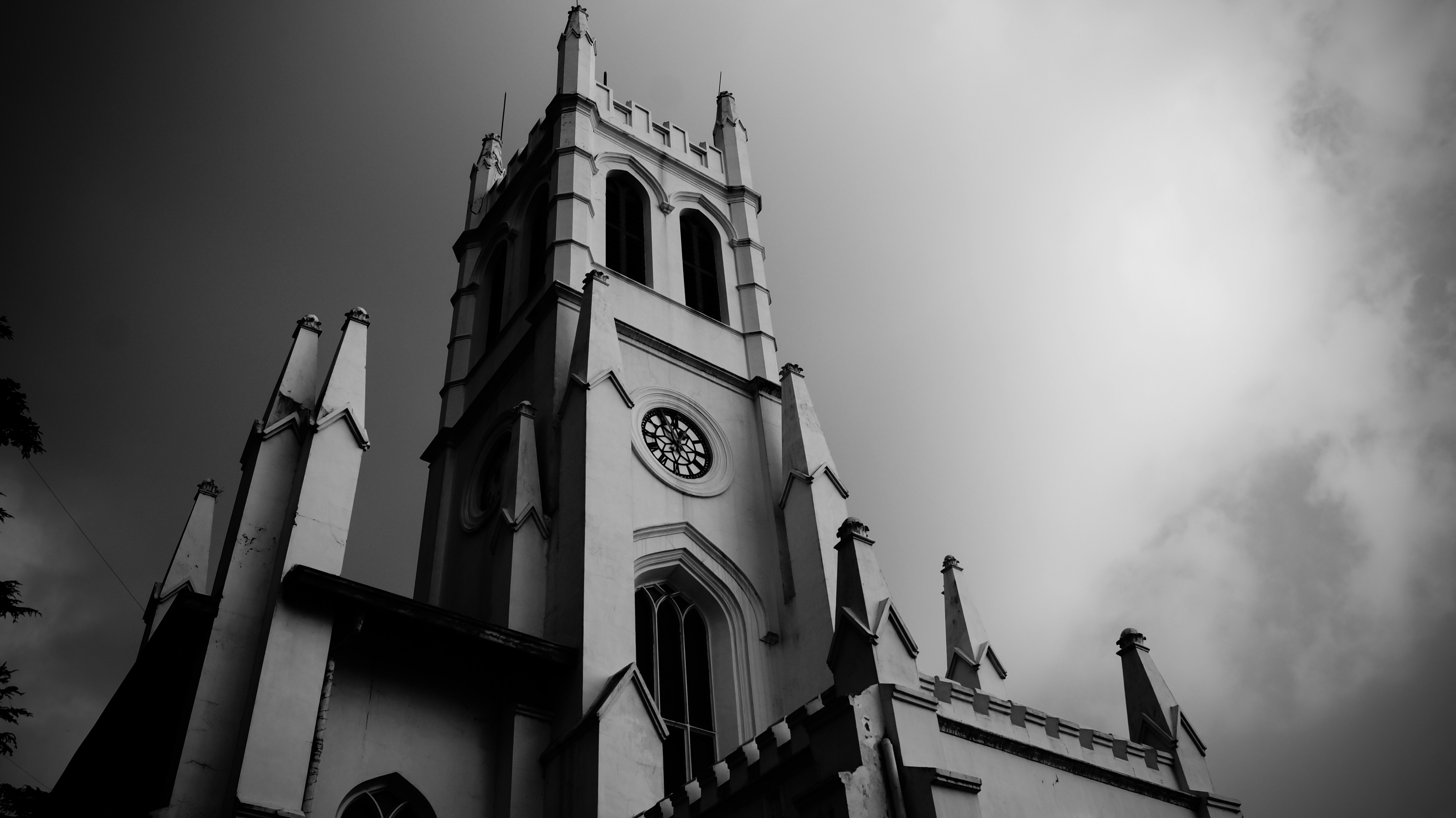 a black and white photo of a church steeple