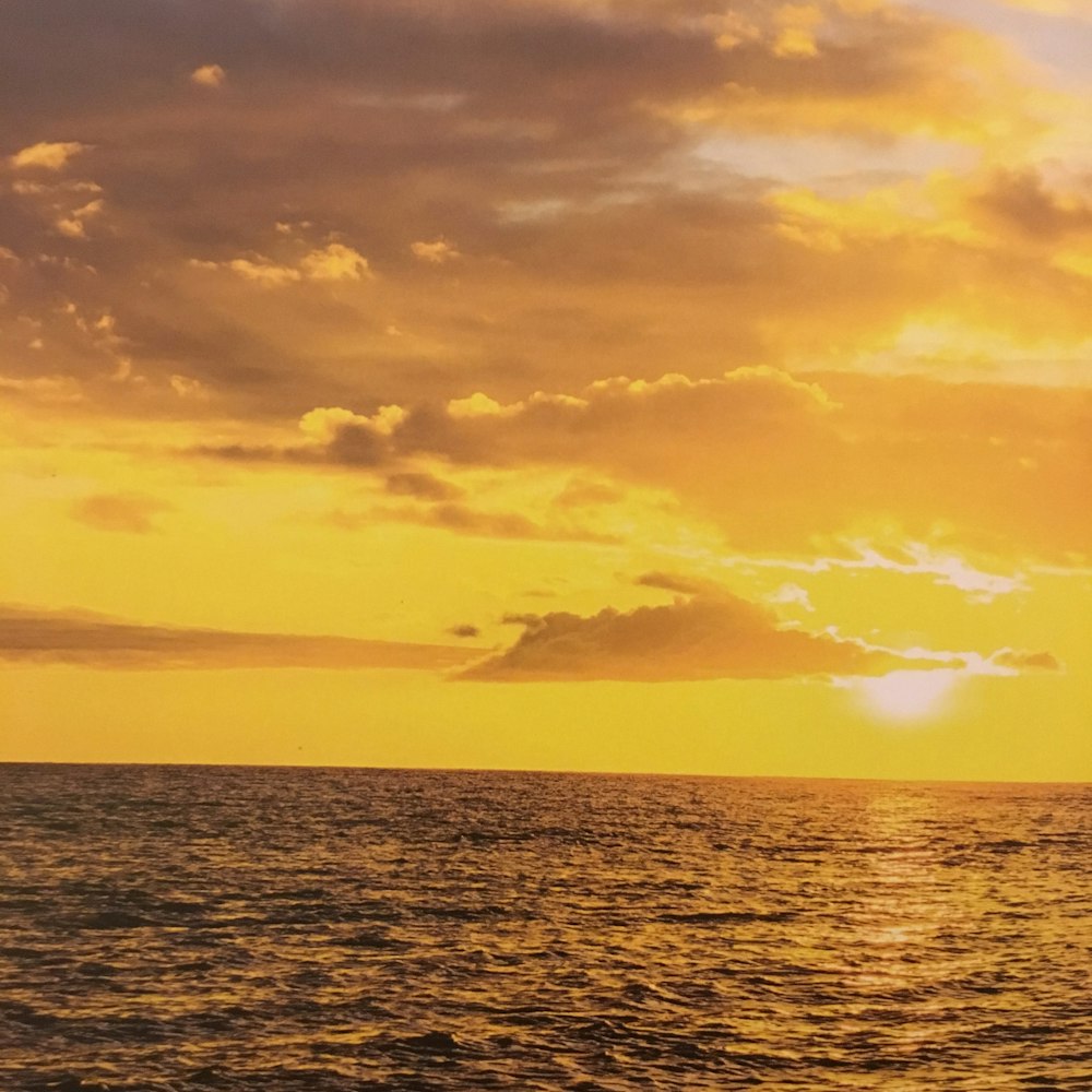 body of water during sunset