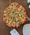 cooked pizza on brown wooden table