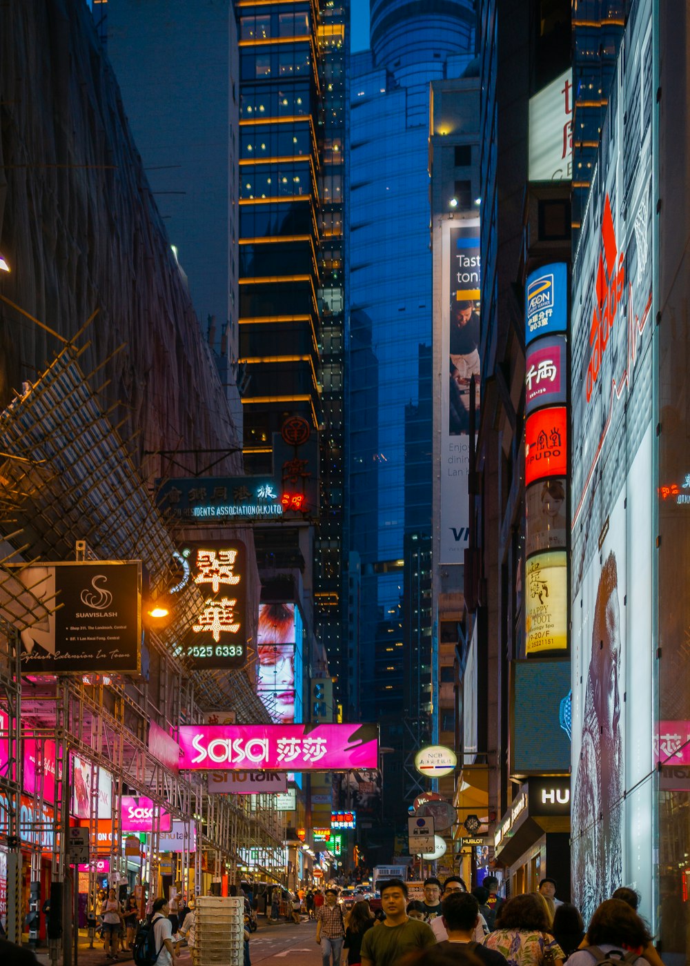 people in busy city street at night