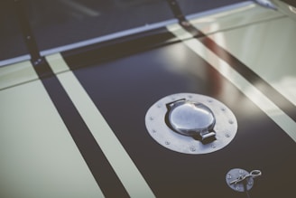 Close-up of a high-performance racing fuel sample in a clear vial with green hues reflecting the brand's theme.
