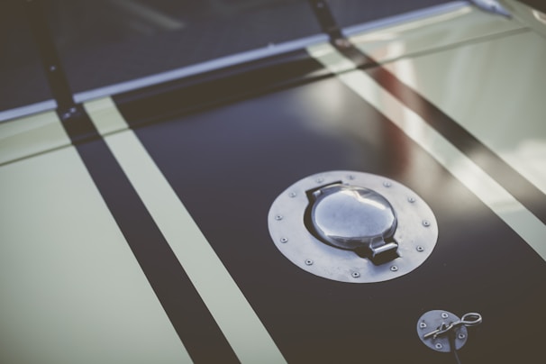 Close-up of a high-performance racing fuel sample in a clear vial with green hues reflecting the brand's theme.