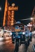 blue auto rickshaw on road