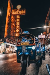 blue auto rickshaw on road