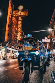 blue auto rickshaw on road