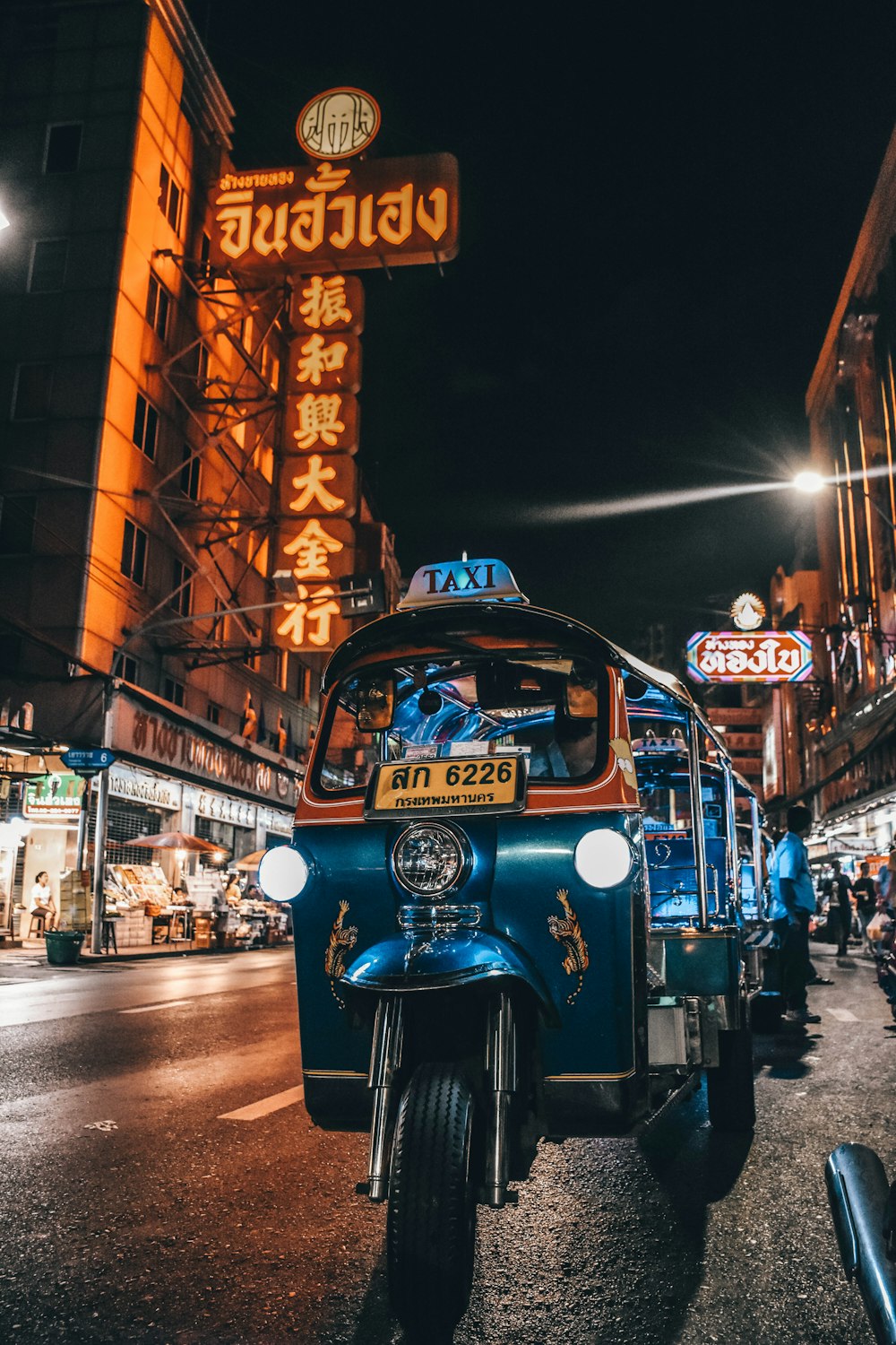 blue auto rickshaw on road
