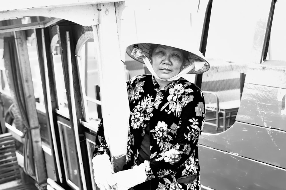 greyscale photo of woman wearing straw hat