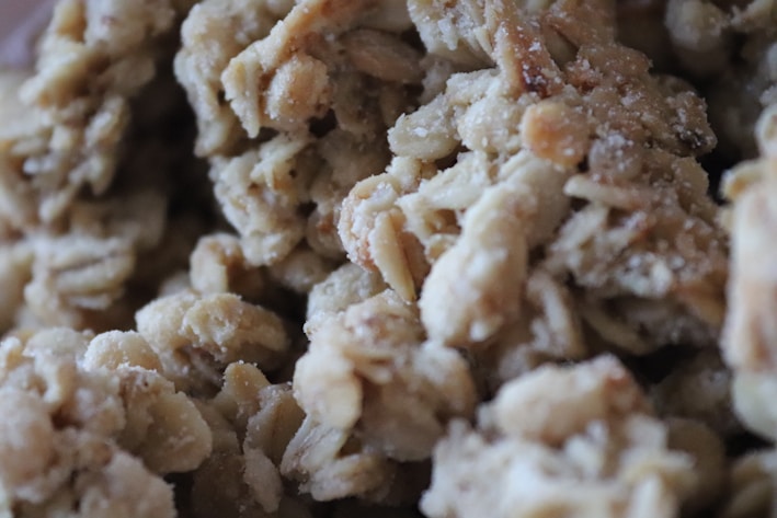 Clusters of granola with visible oats and a slightly crunchy texture.