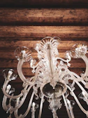 A grand crystal chandelier casting warm light over an elegant dining room.