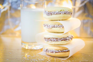 Artisan Peruvian alfajores stacked neatly with powdered sugar dusting.