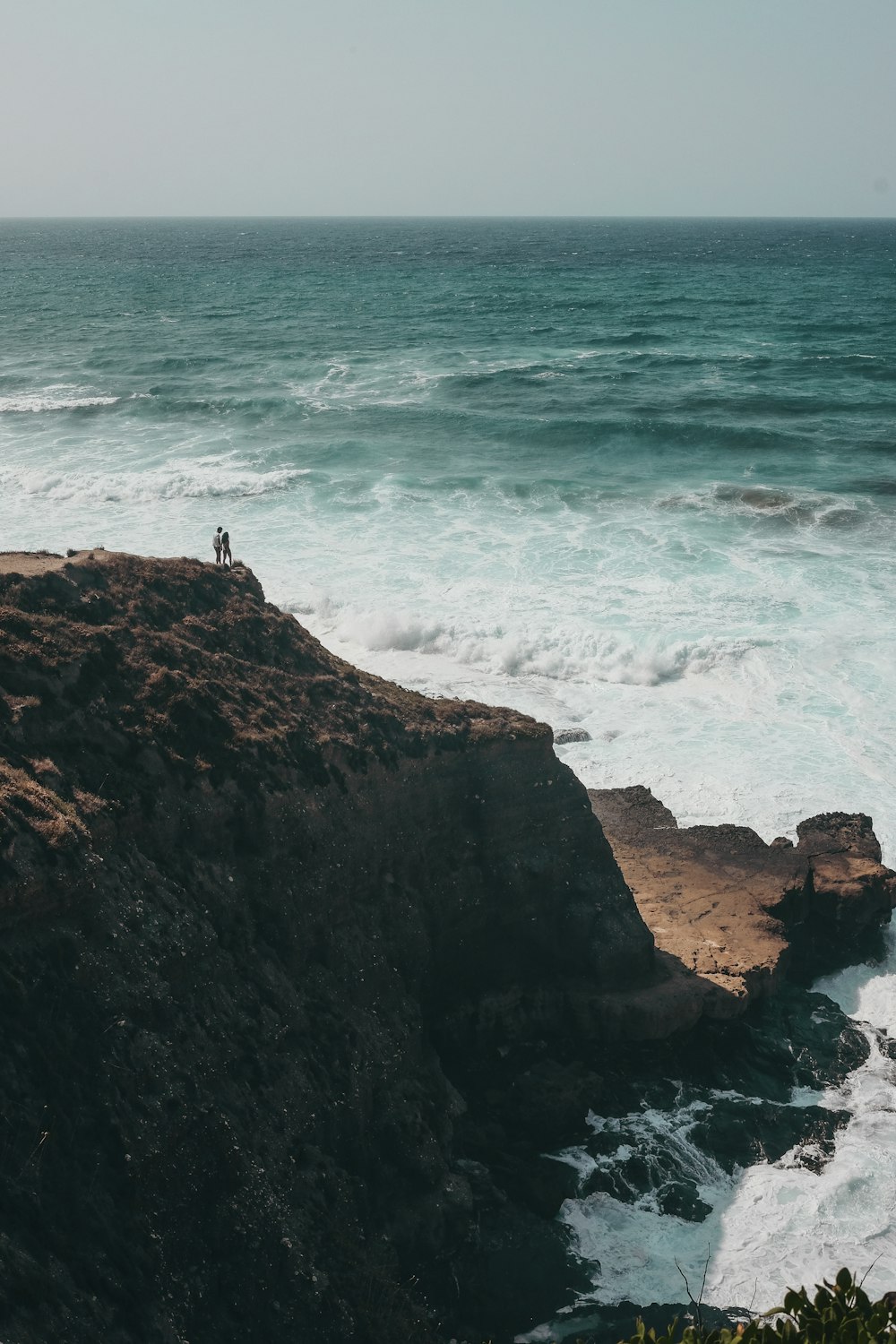 people standing on cliff during daytime