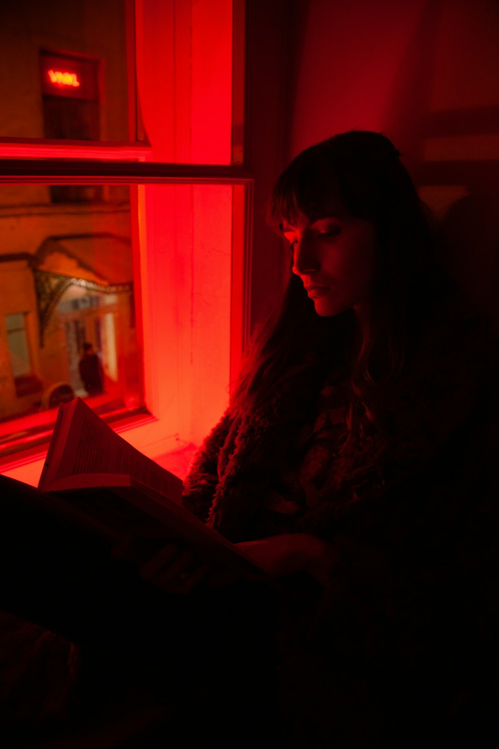 woman sitting near window