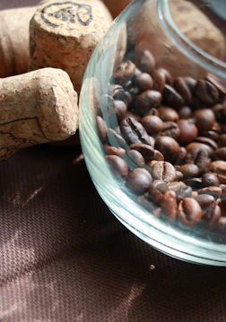 Elegant glass containers holding coffee blends, illuminated by warm, muted lighting.