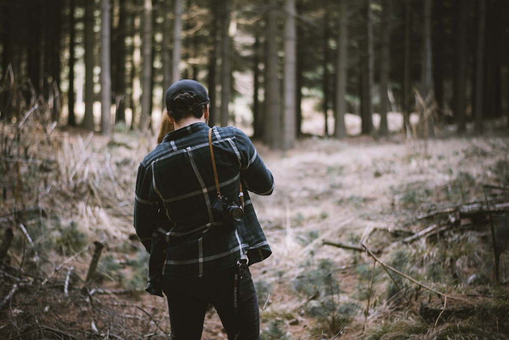 man standing in forest