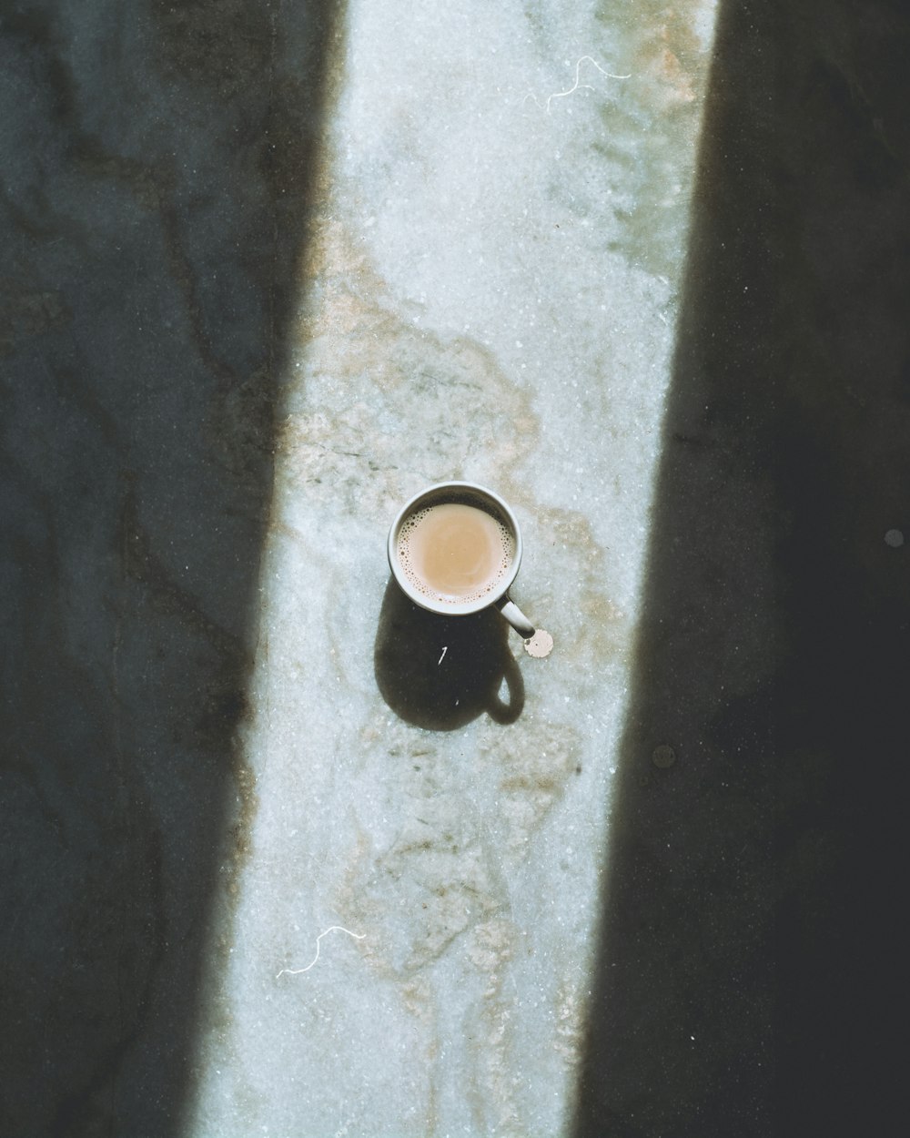 grey ceramic mug on grey surface