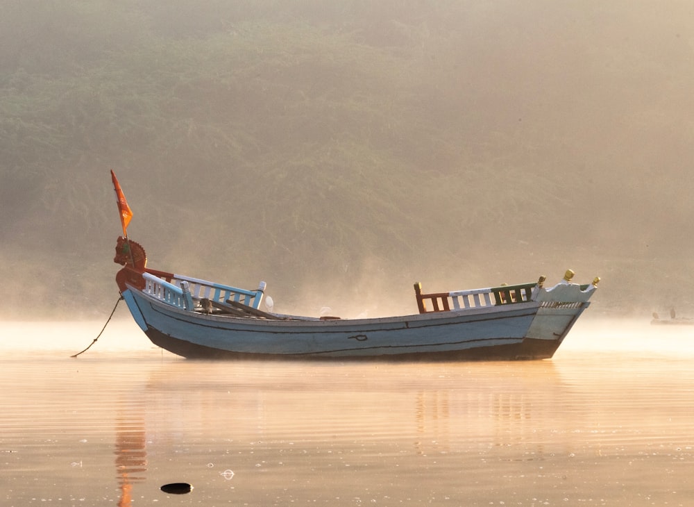 white and brown boat on body of water