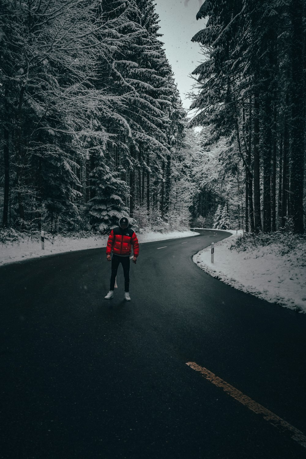 man standing on empty highway