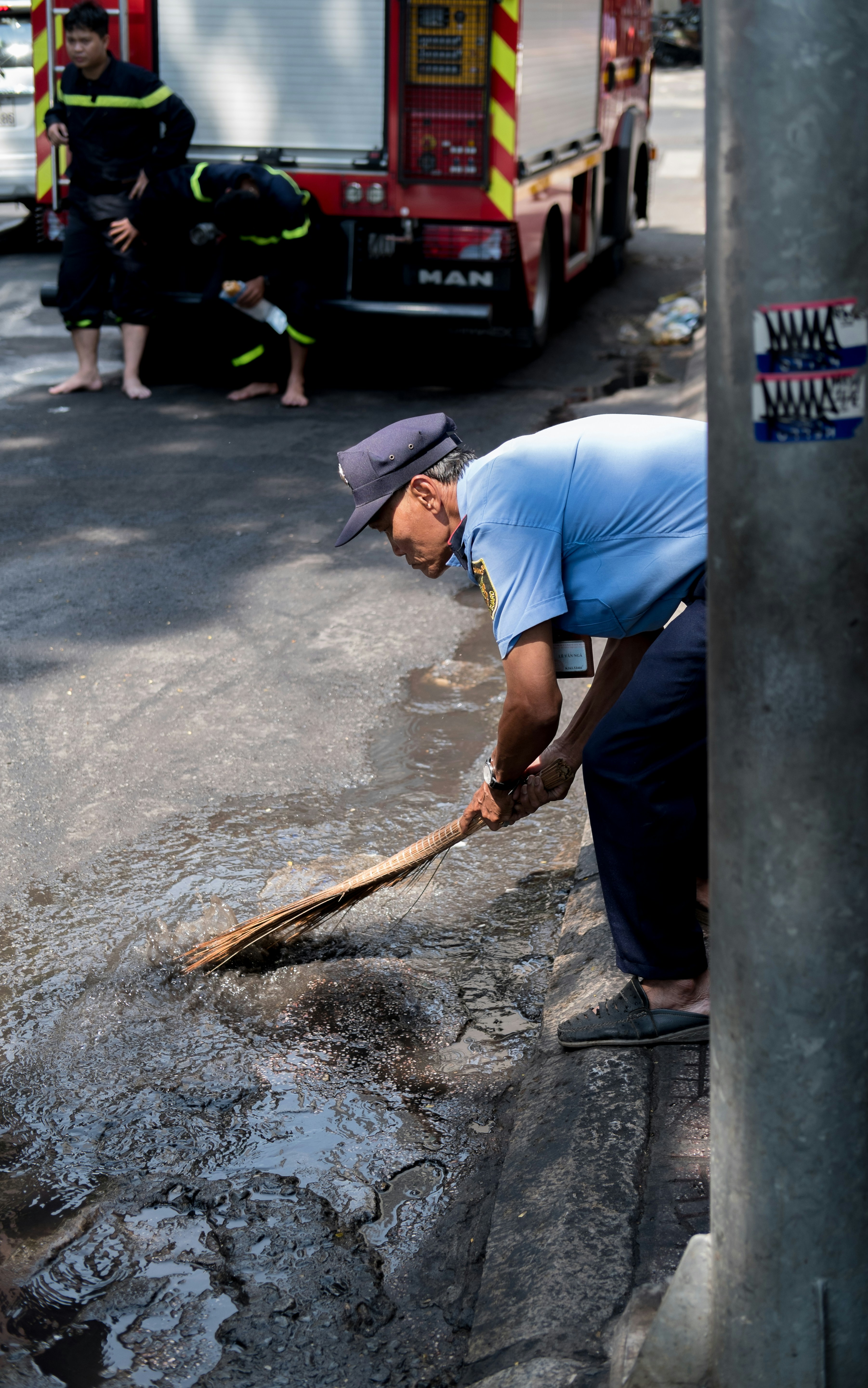 man cleaning at the road