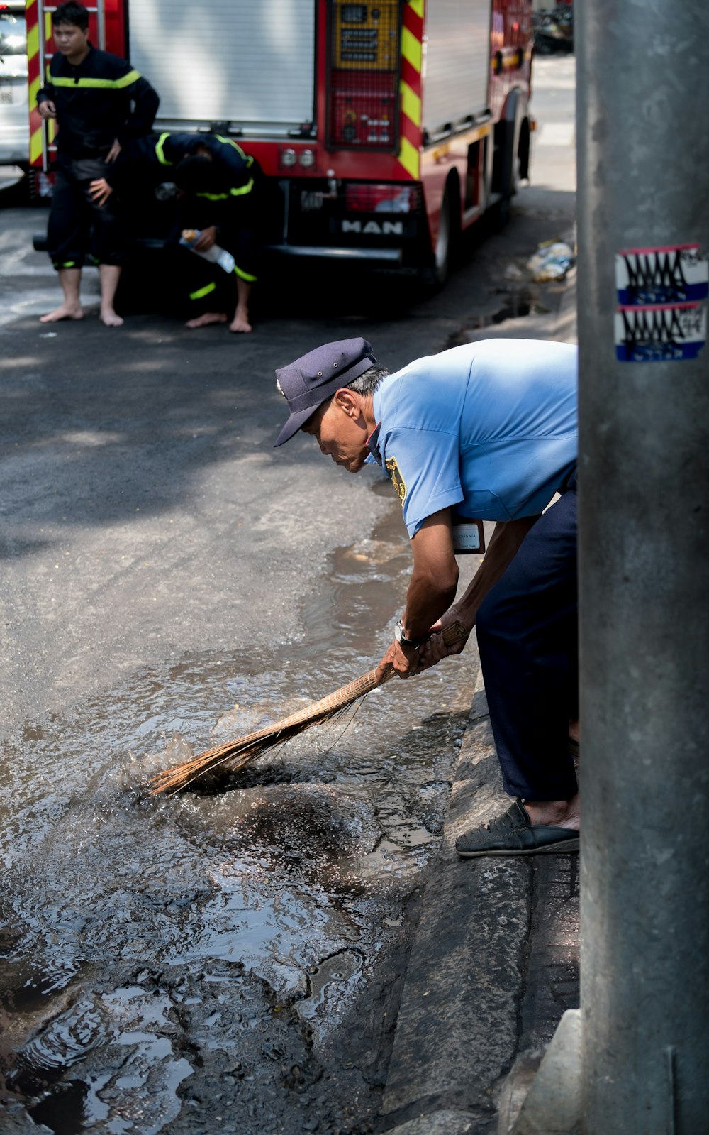 man cleaning at the road