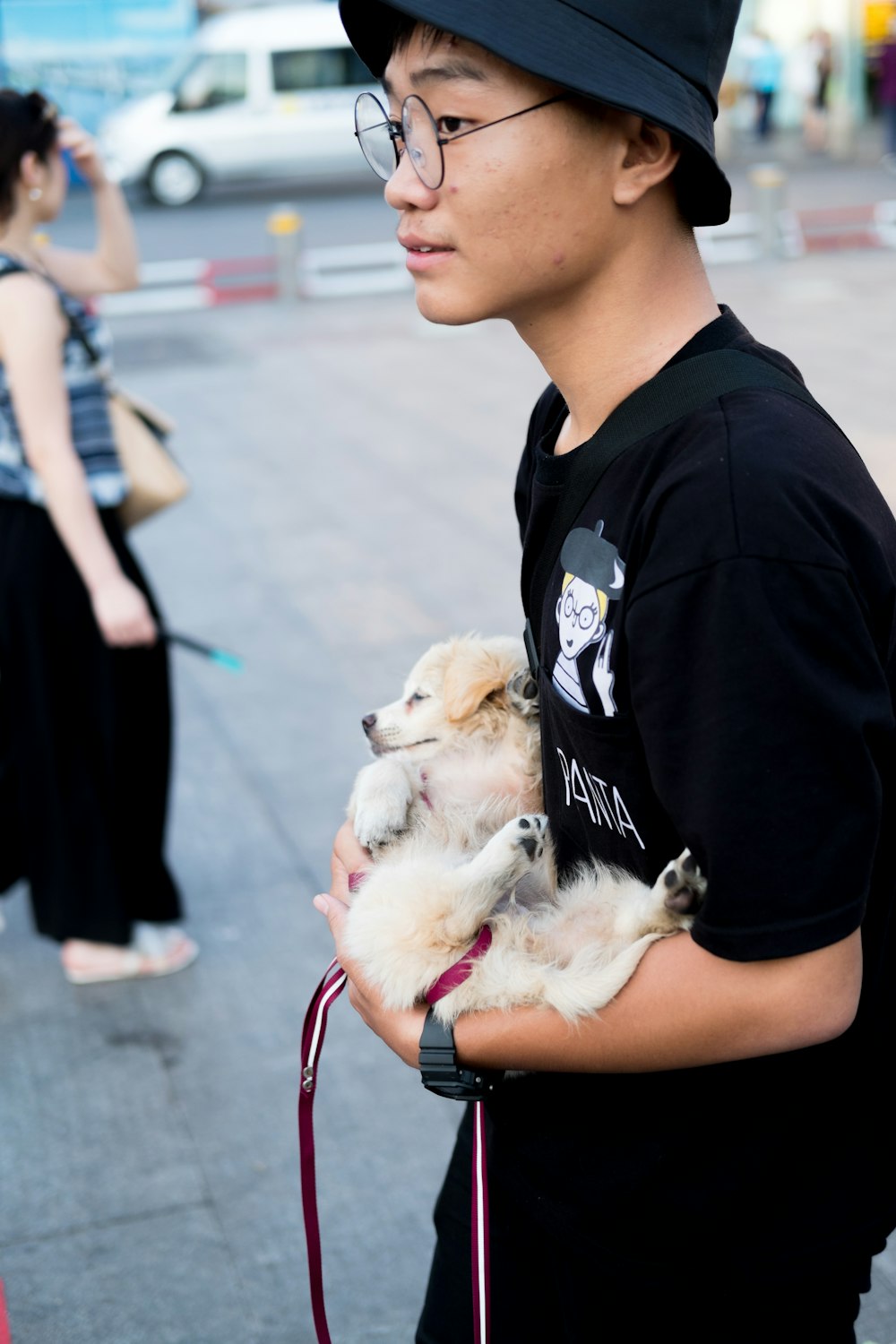 man carrying puppy
