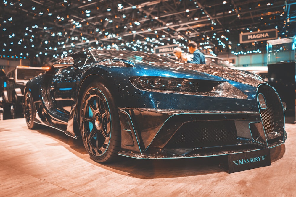 blue Bugatti Veyron parked in well-lit building