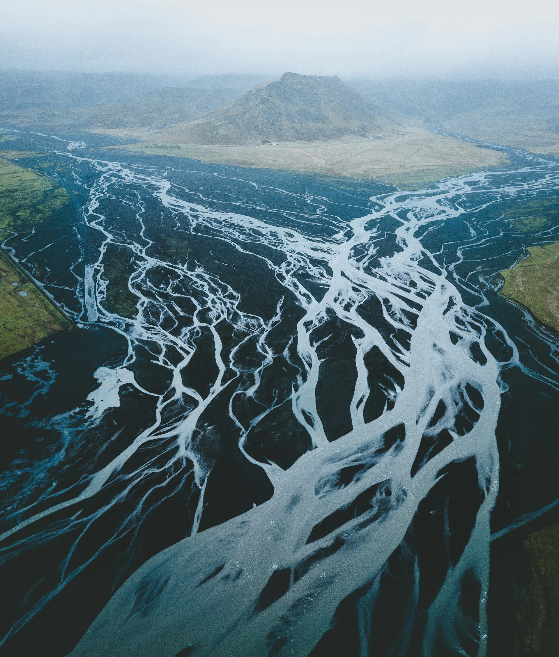 mountain surrounded with body of water