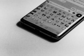 Close-up of a glowing round profile photo with emoji overlays on a mobile screen.