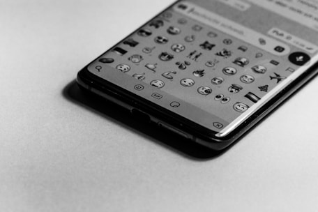 Close-up of a glowing round profile photo with emoji overlays on a mobile screen.