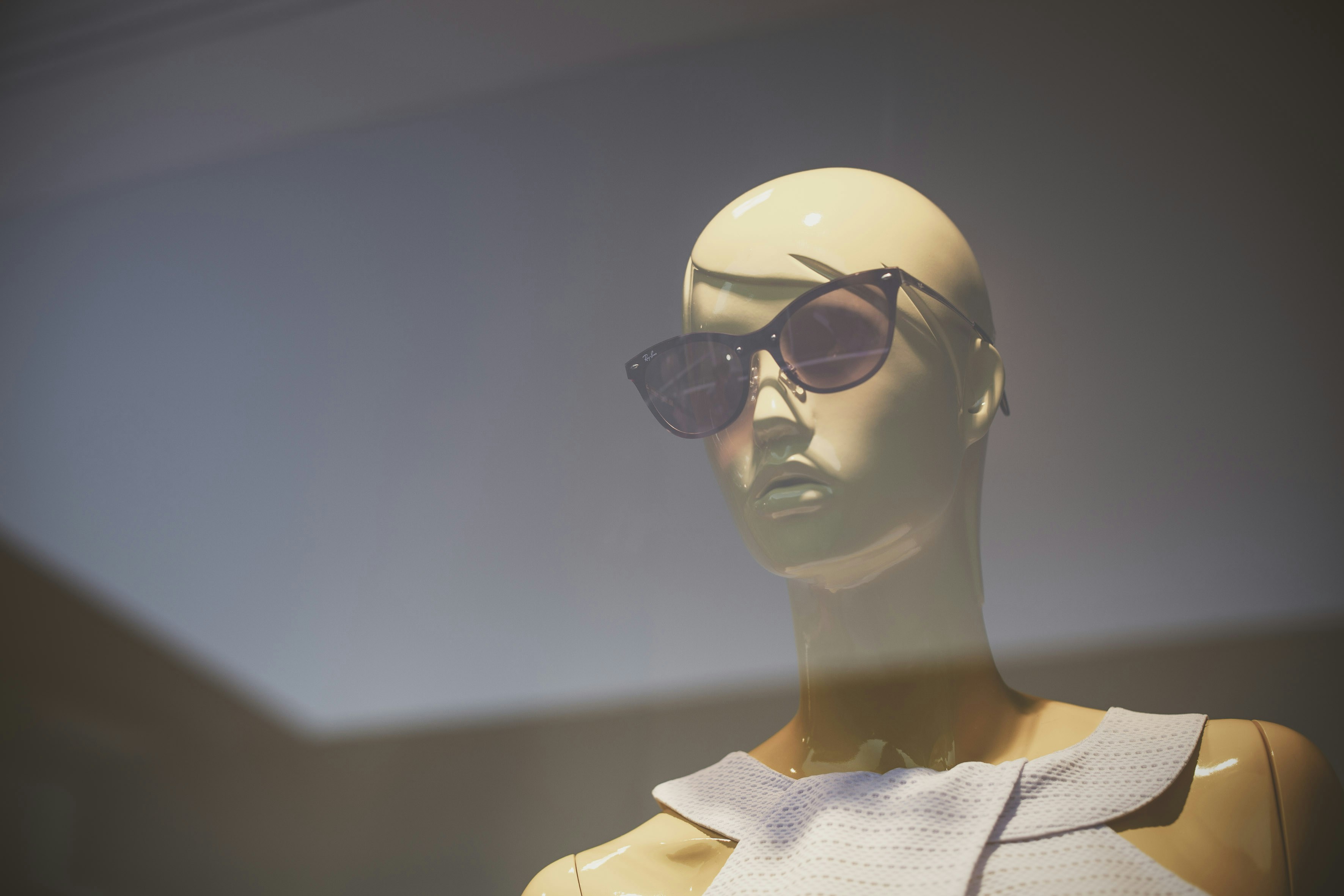 Branimo black cat-eye sunglasses displayed on mannequin