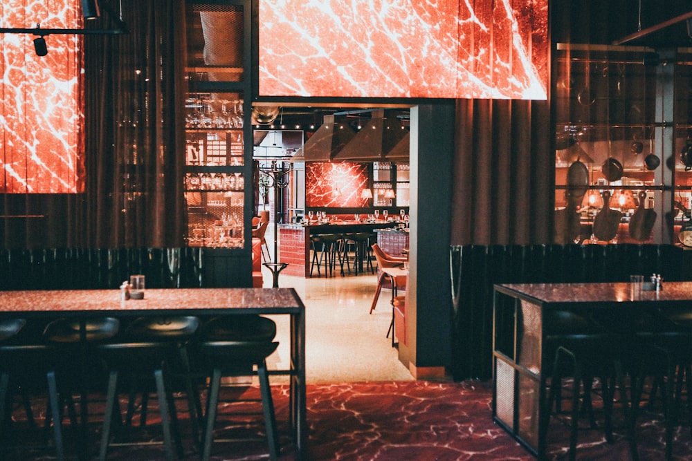 empty chairs and tables inside building with lights turned on