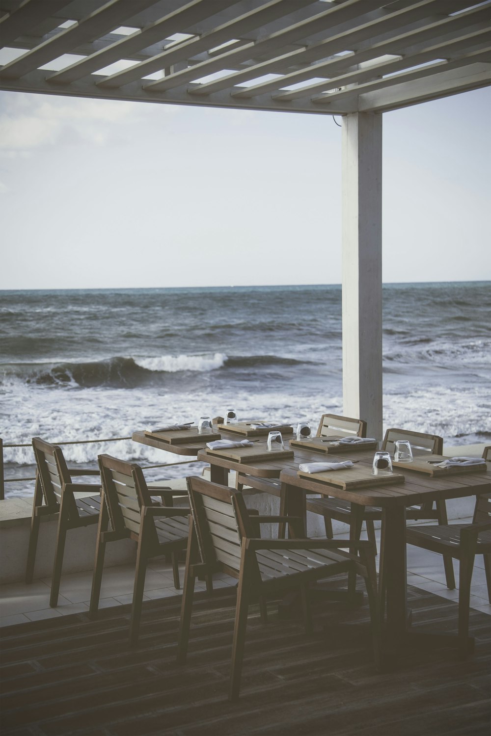 brown wooden table near body of water