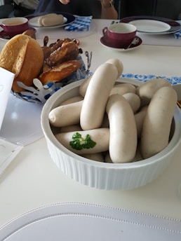 A beautifully arranged catering setup featuring bratwurst and sides.