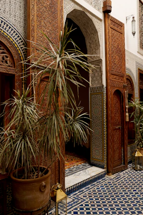 Intricate zellige mosaic detail framing an arched doorway inside the riad.
