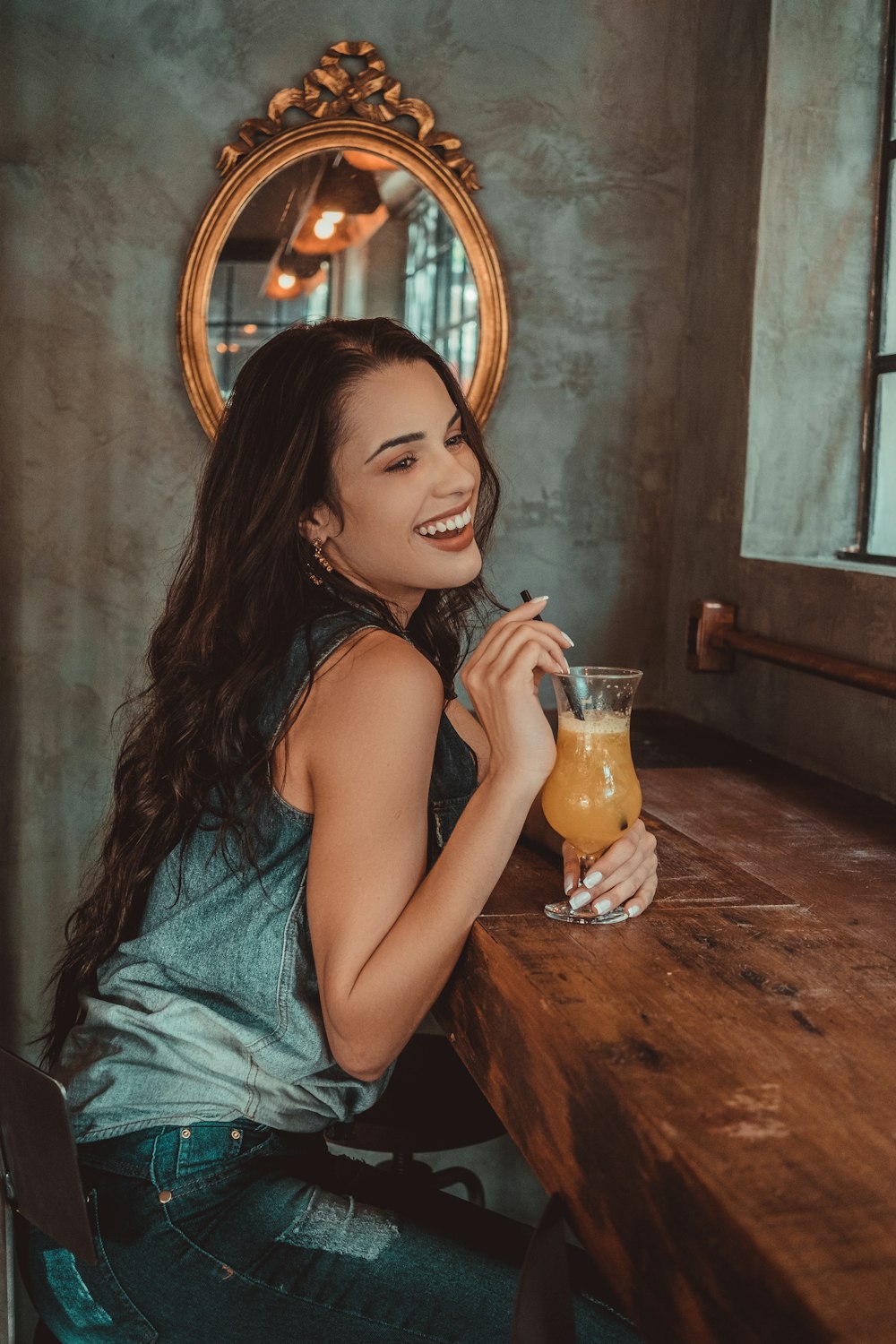 smiling woman sitting on brown tablee