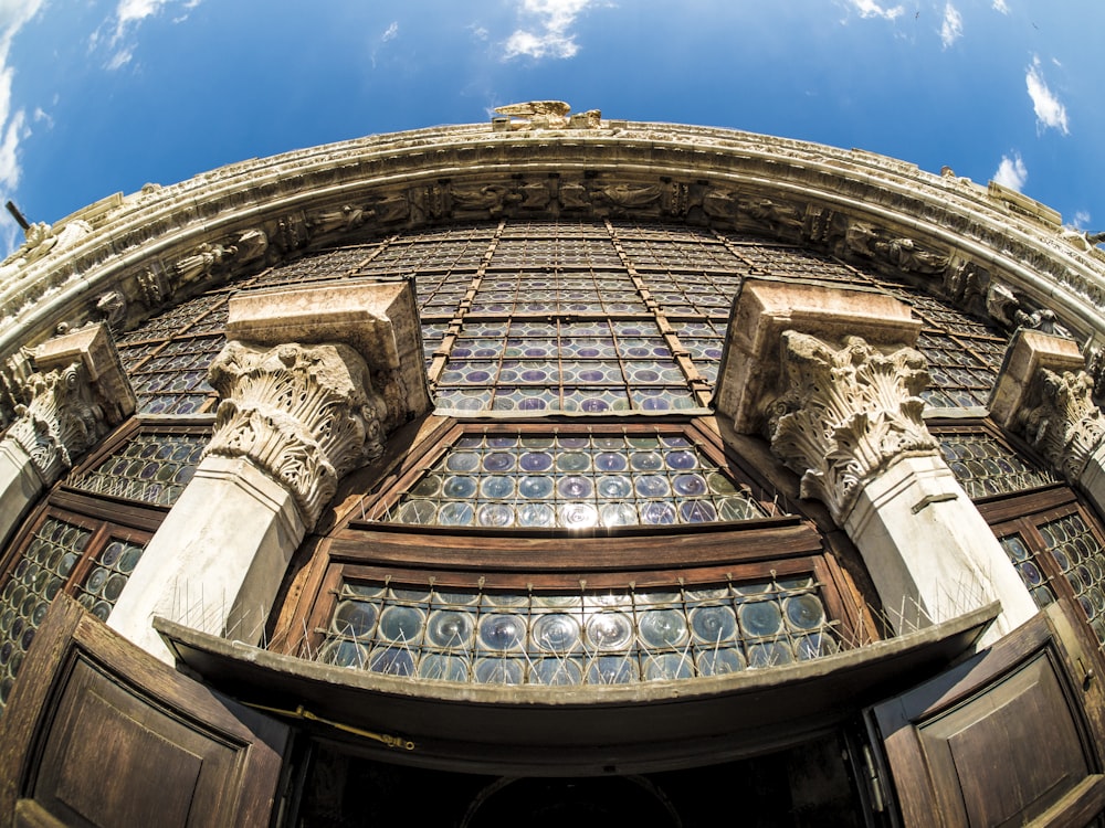 fish-eye photography of high-rise building at blue sky during daytime