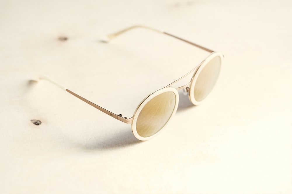brown lens sunglasses on white surface